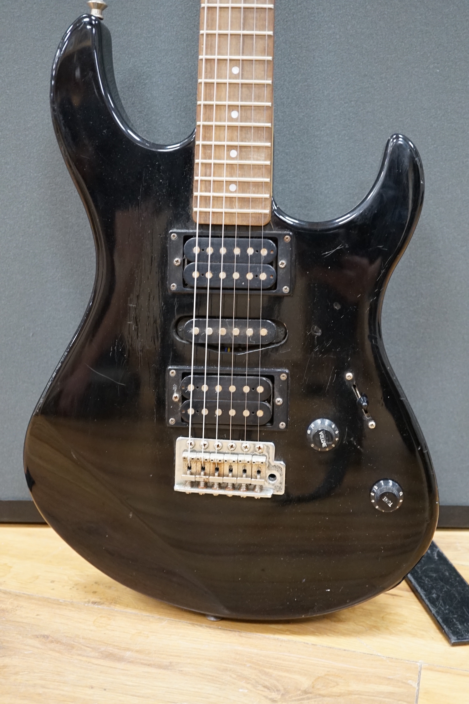 A Yamaha electric guitar, ERG 121, with black lacquer body and a small Carlsbro Kickstart practice amp